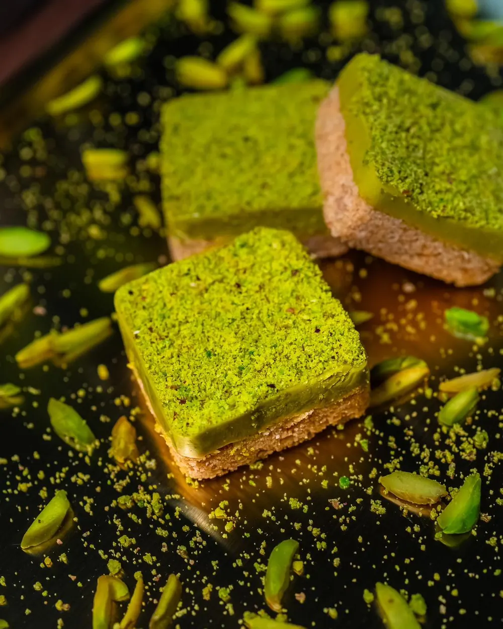 Kunafa pistachio bars on a dark tray