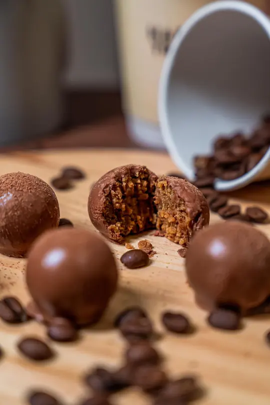 Truffle cut in half next to coffee beans
